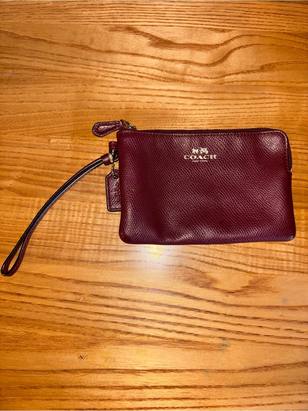 Coach Burgundy Pebbled Leather Wristlet with Gold Logo